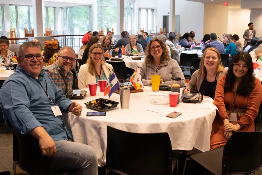 Leaders from many nations, each with a small flag on the table, at the Secret Sauce Conference in Atlanta